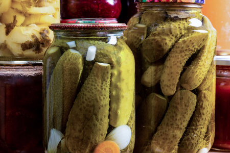 Pickled cucumbers in rolled up jars, close-upの写真素材