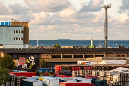 Wladyslawowo, Paland - July 23, 2023: Warehouse, in the background a port and a ship on the Baltic Seaのeditorial素材