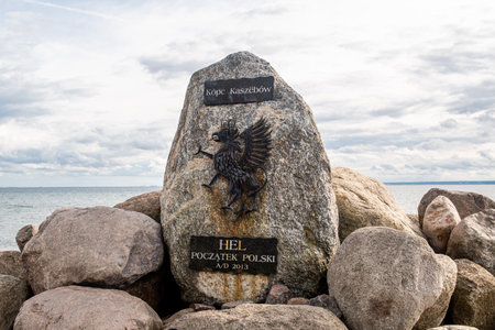 Hel, Pomeranian, Poland - 07.25.2023: Monument to Hel - the beginning of Poland. Stone with commemorative signs and coat of arms on the beach in Hel on the Baltic Sea, Poland.のeditorial素材