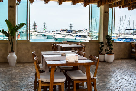 Restaurant with tables in the port overlooking the harbor with yachts on a sunny summer day, Kemer, TÃ¼rkiyeの写真素材