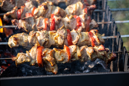 Shish kebab on skewers, it is grilling.close-upの写真素材