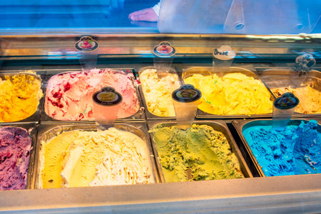 Colorful assorted ice cream flavors in metal containersの写真素材