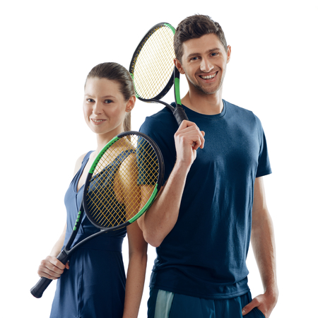 Happy tennis players on white. Woman and man holding racquets and showing enjoyment of game they had.の写真素材