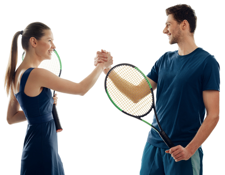 Tennis players greet each other. Happy mood and friendly attitude. Battle of sexes, match.の写真素材