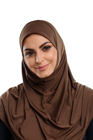 Cute Arabian girl in hijab. Beautiful brown eyes and kind smile on her face. Modesty and piety.の写真素材