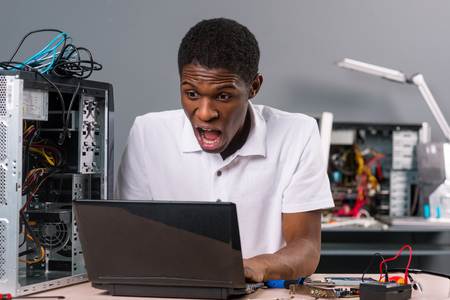 Surprised computer technicianの写真素材