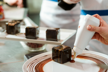Decorating dessert plate with sauceの写真素材