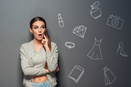 Thoughtful girl with an opened mouthの写真素材