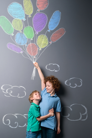 Brothers getting up in skyの写真素材