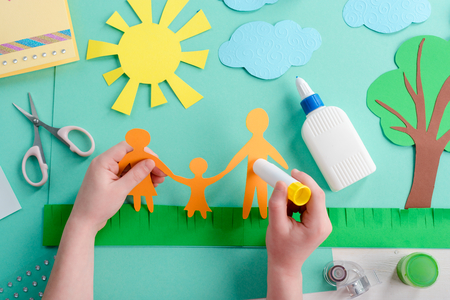 Kid is gluing paper shapeの写真素材