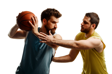 Basketball players fighting for ballの写真素材