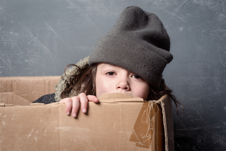 Hungry kid in paper boxの写真素材