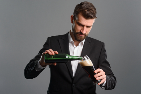 Businessman pouring beer in glassの写真素材
