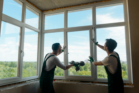 Men are installing a windowの写真素材