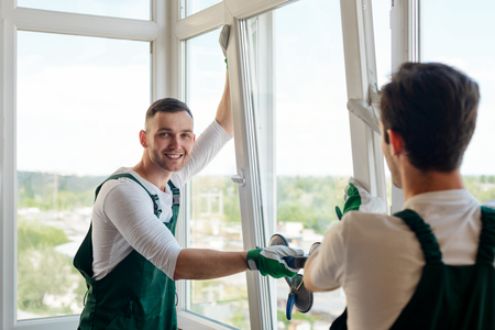 Handsome worker installing a windowの写真素材