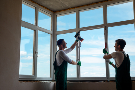 Men are installing a windowの写真素材