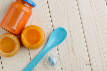 Jarred puree, spoon and pacifierの写真素材