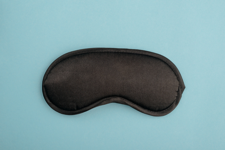 Black eye mask on blueの写真素材