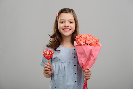 Girl with flowers and lollipopの写真素材