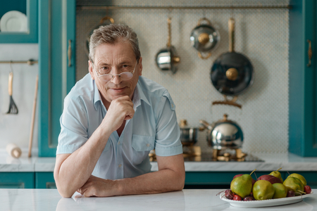 Old man sitting at tableの写真素材