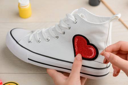 Sewing a heart embroidery patchの写真素材