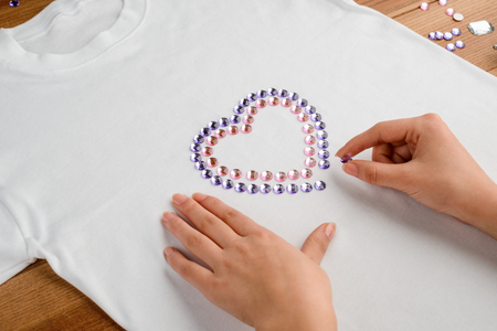 Laying out rhinestones on t-shirtの写真素材