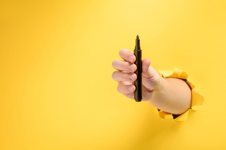 Hand giving a permanent markerの写真素材