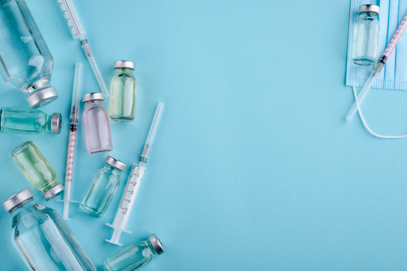 Syringe and vials on blueの写真素材