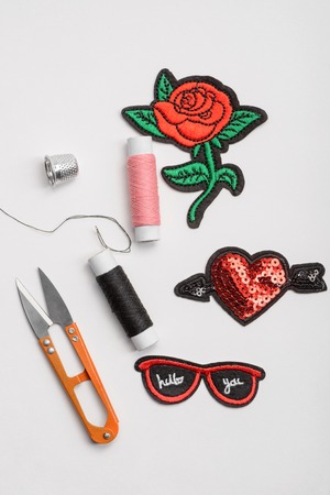 Patches, scissors, thread and thimble