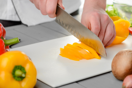 Man slicing a bell pepper