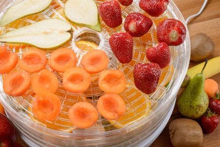 Cut apricots, pears and strawberriesの写真素材