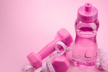 Dumbbels, measuring tape and bottleの写真素材