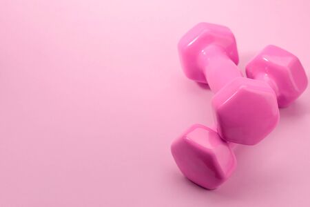 Pair of dumbbells on pinkの写真素材