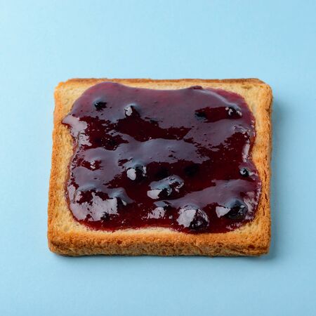 Blueberry jam toast on blue