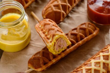 Mouthwatering corn dogs with saucesの写真素材