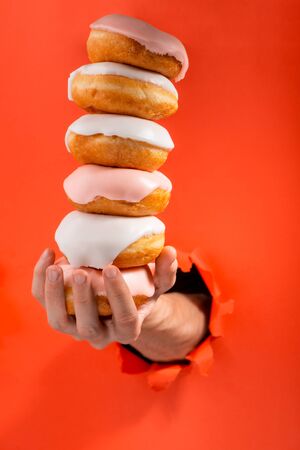 Hand holding donutsの写真素材