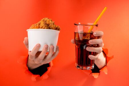 Hands holding nuggets and colaの写真素材