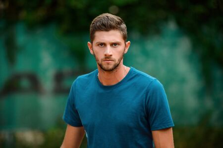 Portrait of a handsome sportsman on an outdoor court.の写真素材
