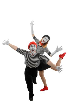 Male and female mimes dancing with wide open armsの写真素材