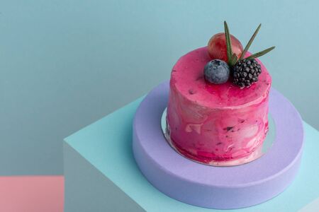 Close-up on vivid pink mousse cake with blackberry and blueberryの写真素材