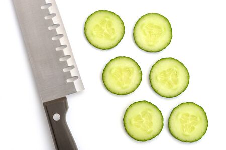 Cucumber slices and a santoku knife on white backgroundの写真素材