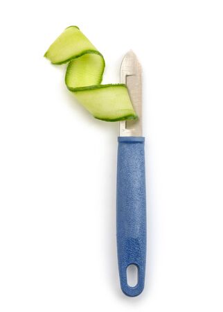 Peeler knife and cucumber shaving. Fresh vegetable cut into ribbon.の写真素材