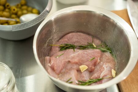 Turkey fillet being marinated with garlic and rosemaryの写真素材
