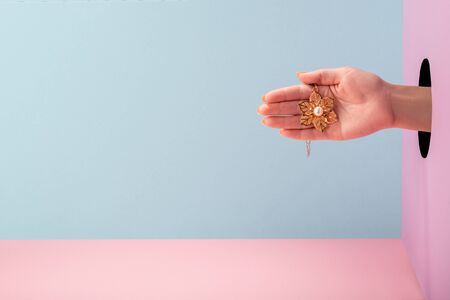 Womans hand holding a flower with chainの写真素材