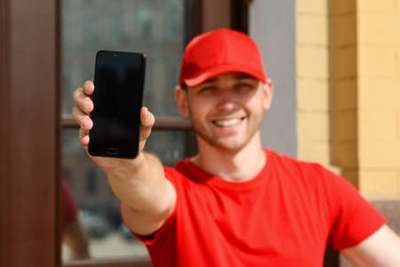 Man is showing a phone, selective focusの写真素材