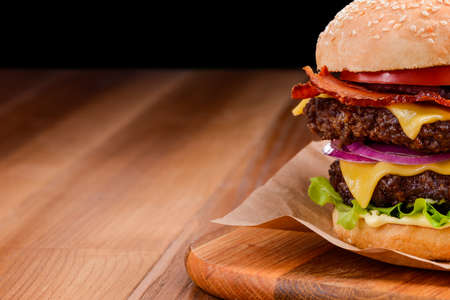 Close up on double cheeseburger on wooden backgroundの写真素材
