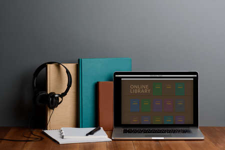 Books, laptop and headphones. Modern education and learning