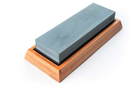 Whetstone in wooden box isolated on white backgroundの写真素材