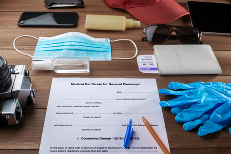 Filling a medical certificate form for travelling during a quarantineの写真素材