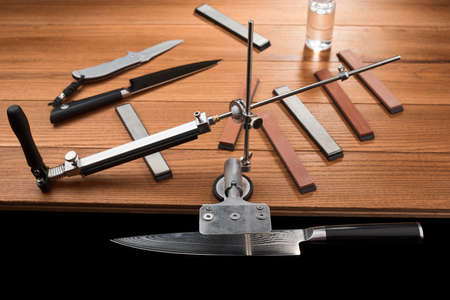 Japanese knife fixed in a manual sharpener machineの写真素材